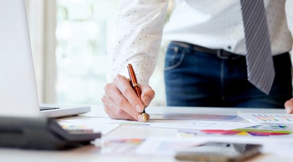 "real estate agent preparing real estate prospecting letters and envelopes at a desk